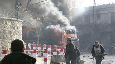 Afghan security men run following a blast in Kabul, Afghanistan 