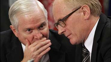 Secretary for Defense Robert Gates, left, whispers to United Nations Special Representative to Afghanistan Kai Eide in Krakow 