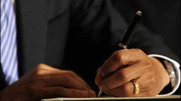 President Obama signing a bill 