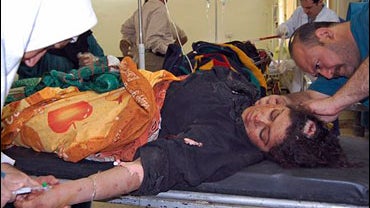 Medics at a central Baghdad, Iraq hospital tend to a woman injured by a car bomb 