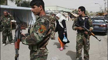 Awakening Council members stand guard in the Dora area of southern Baghdad, Iraq, Saturday, March 28, 2009. 