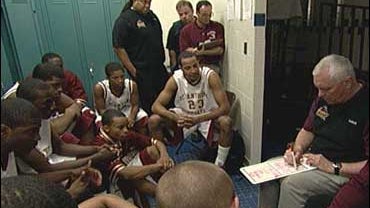 Legendary high school basketball coach Bob Hurley, seated right, goes over plays with his St. Anthony team. 