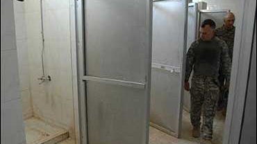U.S. Army Col. Mark Dewhurst surveys completed shower room improvements in a building that will house his soldiers at Joint Security Station in eastern Baghdad 
