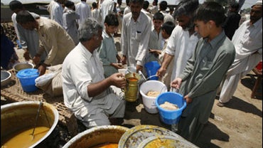 Children wait to receive food at a refugee camp at Swabi, in northwest Pakistan, Sunday, May 10, 2009. 