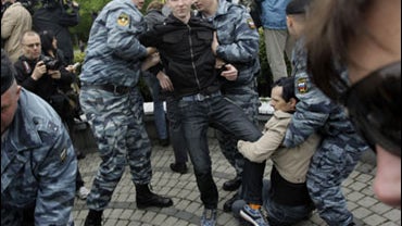 Russian Gay Rights protestors are taken away by riot police officers in Moscow, Russia, Saturday, May 16, 2009. 