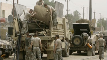 Paratroopers with the 3rd Brigade Combat Team, 82nd Airborne Division load their gear after they handed over their base in central Baghdad, Iraq, to the Iraqi security forces Friday, May 22, 2009. 