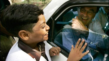 "Slumdog Millionaire" child star Azharuddin Mohammed Ismail, 10, left greets director Danny Boyle as he leaves after a press conference in Mumbai, India, Wednesday, May 27, 2009. 