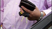 A Shell customer holds his wallet as he pumps gas at a Shell gas station in Menlo Park, Calif,. Wednesday, May 7, 2008. Oil futures extended their seemingly relentless advance Wednesday, rising to a new record near $124 a barrel as investors captivated by 