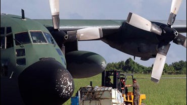 Brazilian Air Force personnel prepare a plane involved in search operations of the missing Air France flight 447 in Fernando de Noronha island, off the northeast coast of Brazil, Friday, June 12, 2009. 