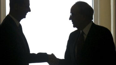 U.S. Mideast envoy George Mitchell, right, shakes hands with with Syrian President Bashar Assad, left, upon his arrival at the Syrian presidential palace, in Damascus, Syria, on Saturday June 13, 2009. 