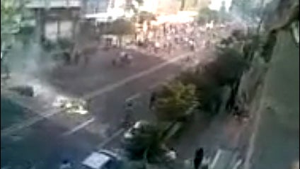 Still frame from a video posted on YouTube purporting to show clashes between demonstrators and riot police in Tehran Saturday, June 20, 2009. A man kicks away a gas canister fired into a crowd. 