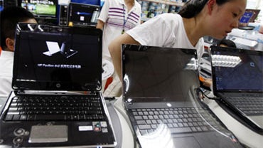 Computers at a store in Beijing, China, June 25, 2009. Beijing is being called upon to revoke an order to personal computer makers that they must install "Green Dam Youth Escort" Web-filtering software (or supply it on a disk) with every computer made for 