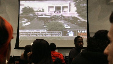 Miami Dade College students watch the Michael Jackson memorial services on a giant screen at Miami Dade College in Miami, Tuesday, July 7, 2009. 