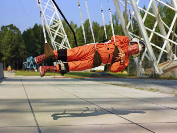 During a 1968 visit to the Langley Research Center, the adventurous Walter Cronkite tried out the Reduced Gravity Walking Simulator - a series of cable-supported slings hanging from the Lunar Landing Research Facility designed to approximate lunar locomo 