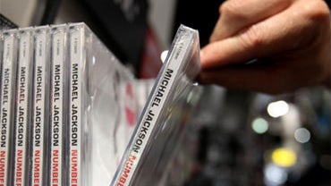 A customer picks up a copy of a Michael Jackson album on Friday, June 26, 2009 in London. 