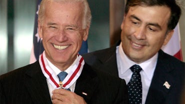 Visiting U.S. Vice President Joe Biden reacts after receiving an award from Georgia's President Mikhail Saakashvili, background, during a reception in honor of Biden, Tbilisi, Georgia, July 22, 2009. 