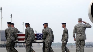 An Army carry team carries a transfer case containing the remains of Army Spc. Randy L.J. Neff Jr. Friday, July 24, 2009 at Dover Air Force Base, Del. 