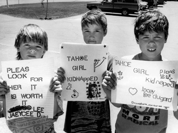 Boys hold signs searching for jaycee lee dugard 