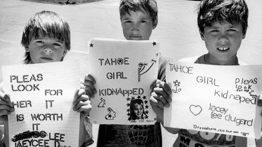 Boys hold signs searching for jaycee lee dugard 