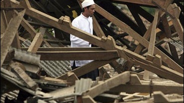 A Muslim man walks by the ruins of school destroyed by an earthquake in Pengalengan, West Java, Indonesia, Friday, Sept. 4, 2009. The 7.0-magnitude quake rocked southern Indonesia on Wednesday, unleashing mudslides that buried villagers in their homes. (A 