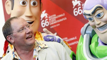 Director John Lasseter poses with life-size models of characters from Pixar's animated movies, at the 66th edition of the Venice Film Festival in Venice, Italy, Sunday, Sept. 6, 2009. 
