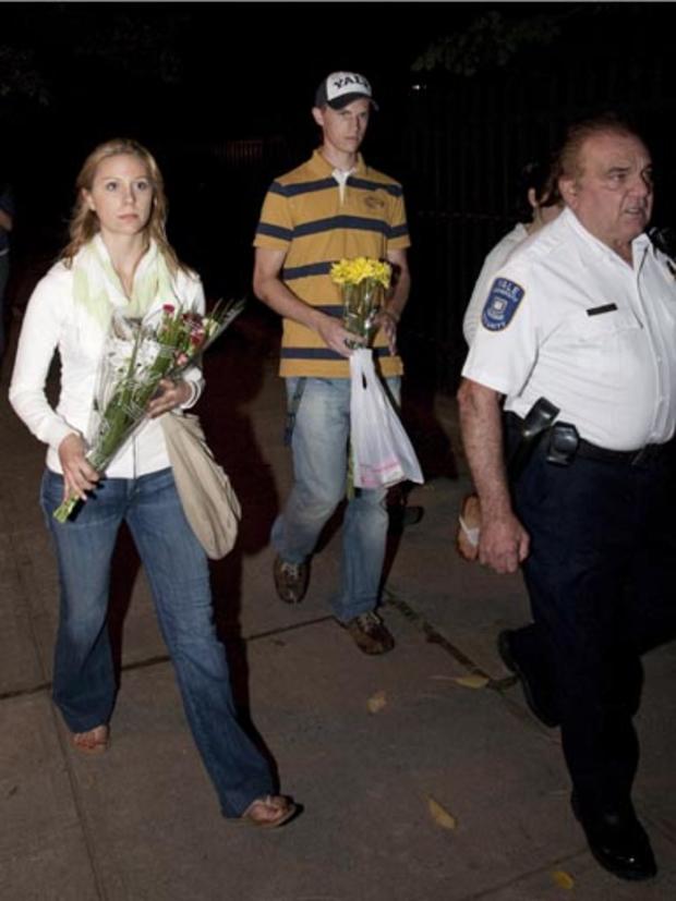 Yale University Grad students carry flowers in front of 10 Amistad Street late Sunday night in New Haven, Conn., Sunday, Sept 13, 2009. 