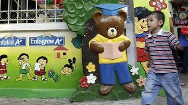 In this photo taken Friday, Oct. 3, 2008, a milk company's advertisements are seen on the wall of nursery school in Hanoi, Vietnam. 