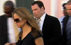 John Travolta, right, exits a Nassau courtroom in the Bahamas after testifying against two men who allegedly tried to extort $25 million from the movie star. During his testimony, Travolta admitted for the first time his son had autism. 