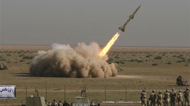 In this photo released by the Iranian semi-official Fars News Agency, Revolutionary Guard's Tondar missile is launched in a drill, Sunday Sept. 27, 2009, near the city of Qom 