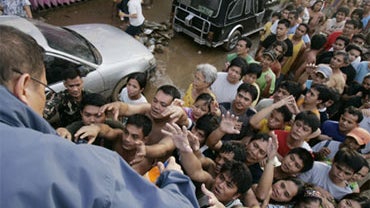 Residents receive relief goods in suburban Marikina city, east of Manila, Philippines on Monday, Sept. 28, 2009. 