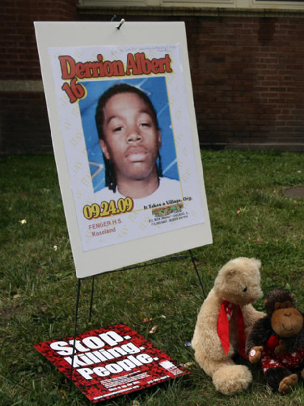 SLIDESHOW - Ava Johnson, mother of Eugene Riley, who has been charged with beating to death 16-year-old Derrion Albert on Sept. 24, talks to the media as she holds her son photo at Fenger High School in Chicago, Monday, Sept. 28, 2009. Johnson said her so 