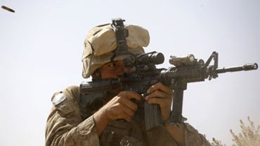 During a firefight with Taliban militants, a spent shell casing flies through the air as U.S. Marine Lance Cpl. Jordan Christie, of Washington, Ind. with 3rd Platoon, Bravo Company, 1st Battalion 5th Marines returns fire, in Nawa district, Helmand provinc 