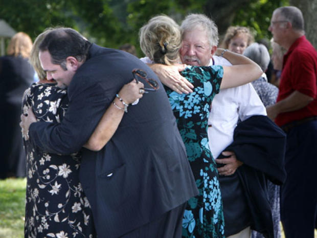 Friends and members at Walker's Presbyterian Church in Hixburg, Va. hug each other after a graveside service for Rev. Mark Niederbrock on Thursday, Sept. 24, 2009. Niederbrock was buried in front of his modest white church in Appomattox County nearly a we 