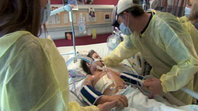 Hugh Estlinbaum and his wife Lizzy watch over their son Tony in Oklahoma City, Oklahoma. Tony has been battling the H1N1 flu. 