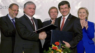 Armenian foreign minister Edouard Nalbandian (center left), and Turkish foreign minister Ahmet Davutoglu (center right) shake hands, while European Union foreign affairs chief Javier Solana, French foreign minister Bernard Kouchner, and U.S. Secretary of  