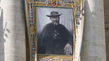 A view of the tapestry of new saint Father Damien, on display on the facade of St. Peter's Basilica at the Vatican Sunday, Oct. 11, 2009. 