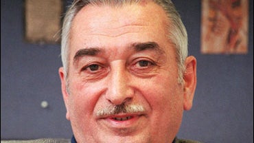 FILE - In this March 3, 1999 file photo, grandson of the late Soviet dictator Josef Stalin, Yevgeny Dzhugashvili, wearing a "USSR" lapel pin, is photographed during an interview in Moscow. A Moscow court began hearings Thursday in a libel suit brought by  