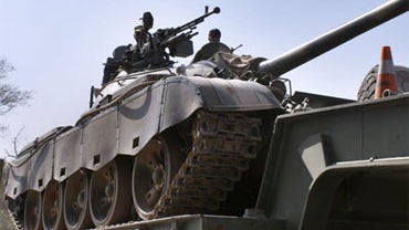 A Pakistan army tank is transported by truck passing through Bara, the main town of Pakistan's tribal region Khyber along the Afghan border, on Sunday, Oct. 18, 2009. 