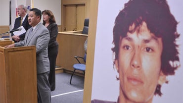 David Shinn, at podium, deputy chief of the San Francisco police department, speaks during a news conference while standing beside a photograph of "Night Stalker" Richard Ramirez at the Hall of Justice in San Francisco, Thursday Oct. 22, 2009. San Francis 
