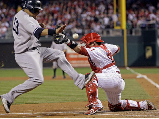 Melky Cabrera slides safely past Philadelphia Phillies catcher Carlos Ruiz 