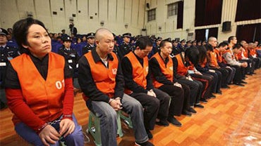 Xie Caiping, left, and other gangster suspects stand trial at the Chongqing No.5 Intermediate People's Court in Chongqing, China, Tuesday, Nov. 3, 2009. The woman called the "godmother" of a mafia-style gang in China's southern city of Chongqing was sente 