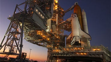 As the sun sets behind Launch Pad 39A at NASA's Kennedy Space Center in Florida, the rotating service structure has been moved away from space shuttle Atlantis. 