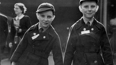 In this Oct. 6 1950 photo, 10-year-old twins Brian Thomas Sullivan (left) and Kevin James Sullivan from Islington carry their luggage to the boat train "Rangitoto" as they leave Liverpool Street station in London bound for Auckland, New Zealand. Britain a 