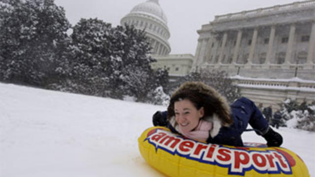 Amanda Gibson uses a tube to slide down the hill in the snow on the West Front of the U.S. Capitol in Washington, Saturday, Dec. 19, 2009. 