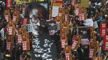 Pro-democracy protesters march toward the China's Liaison Office as they demand the universal suffrage at year 2012 and release mainland dissident Liu Xiaobo in Hong Kong Friday, Jan. 1, 2010. 