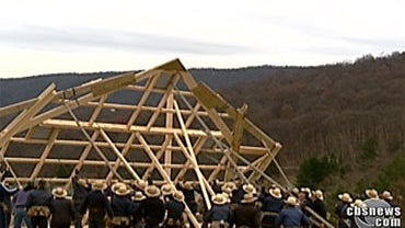 Amish neighbors help John Helmstetter rebuild his barn. 