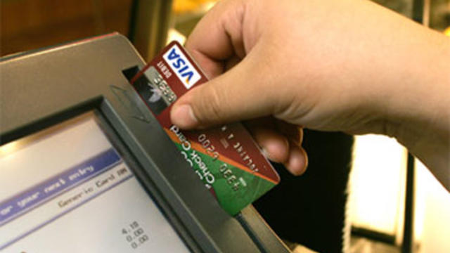 In this October 2006 file photo cashier Angela Ramirez swipes the debit card ot Julayne Miller as Miller makes her lunch purchase at Villa Pizza in the Purdue Memorial Union on the campus of Purdue University in West Lafayette, Ind. 