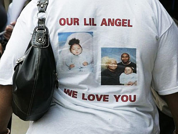 A relative, who wanted to remain unidentified, of Lorrie Mae Thomas, the adoptive mother of a 9-year-old quadriplegic girl whose body was found in a Michigan storage unit wears a T-Shirt with photos of Shylae Myza Thomas in Flint, Mich., Friday, April 24, 