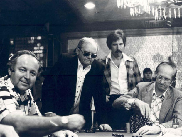 Benny Binion, standing second left, oversees a World Series of Poker game at The Horsehoe in the early 1970s. The mustached man to his right is present-day Las Vegas mogul Steve Wynn. 