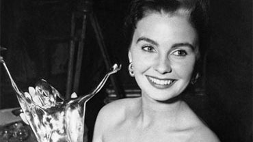 In this May, 24, 1950 file photo, Jean Simmons, British screen actress, holds the trophy she receives in London after being voted her country's No. 1 film actress of the year in the fifth National Film Award ballot. 
